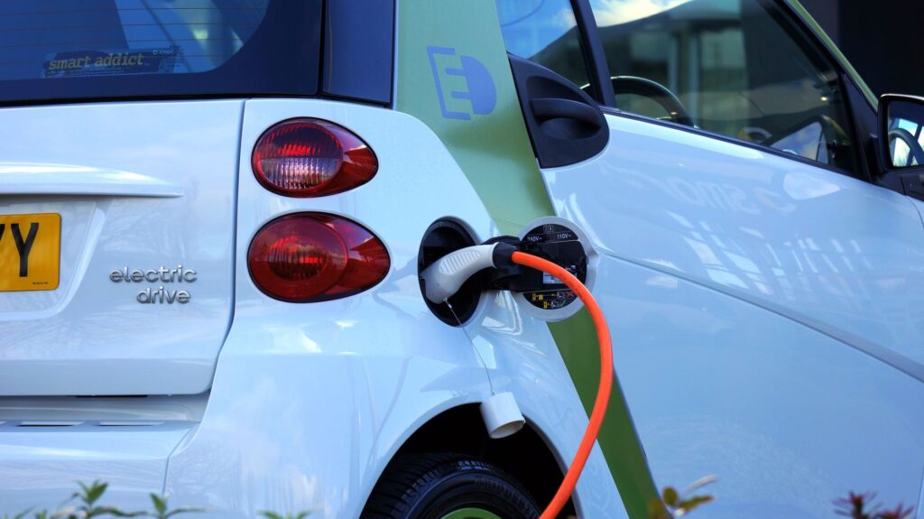 Zbliżenie na samochód elektryczny podłączony do ładowania